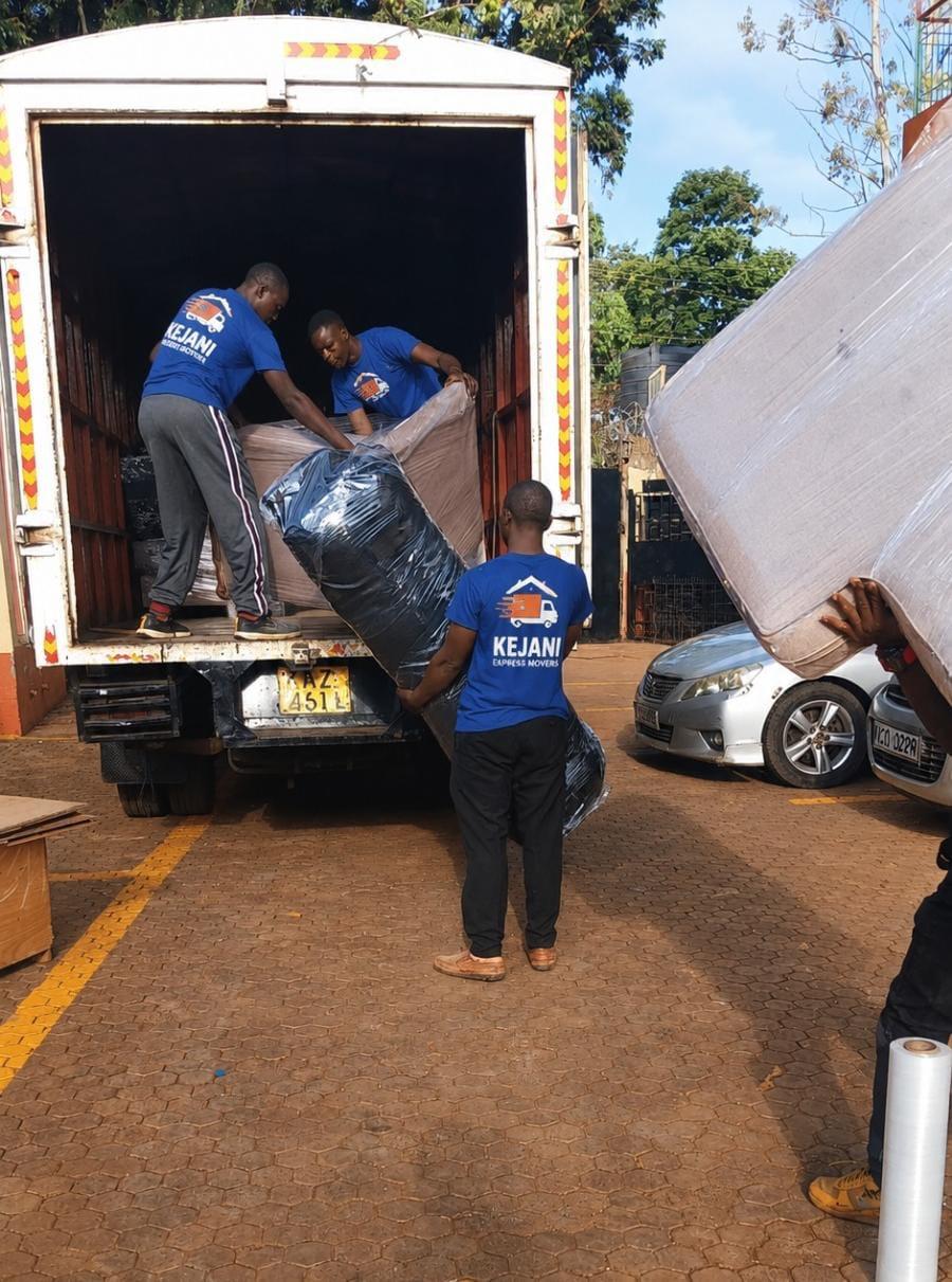 Kejani crew loading wrapped furniture into the moving truck